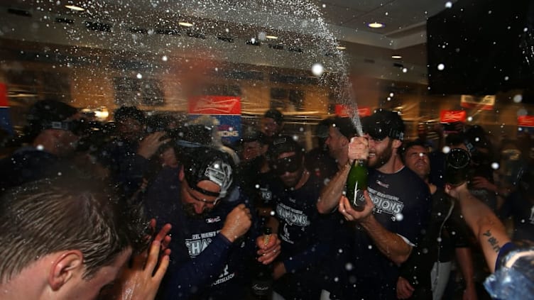 LOS ANGELES, CA - SEPTEMBER 22: Tony Cingrani #54 of the Los Angeles Dodgers sprays champagne in the clubhouse after their 4-2 win a MLB game against the San Francisco Giants to clinch their fifth consecutive National League West Division title at Dodger Stadium on September 22, 2017 in Los Angeles, California. (Photo by Victor Decolongon/Getty Images)