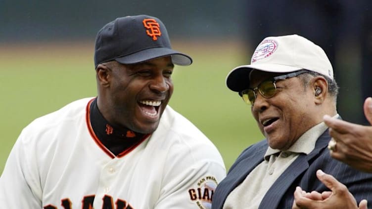 SF Giants slugger Barry Bonds laughs with godfather Giants legend Willie Mays at Giants Opening Day against the San Diego Padres in 2002. (JOHN G. MABANGLO/AFP via Getty Images)