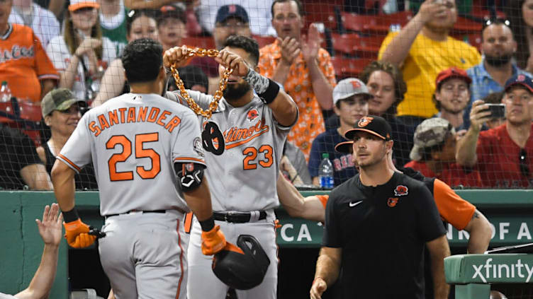 Robinson Chirinos #23 places a chain around Anthony Santander #25 of the Baltimore Orioles after he hit a three run home run. (Photo by Kathryn Riley/Getty Images)