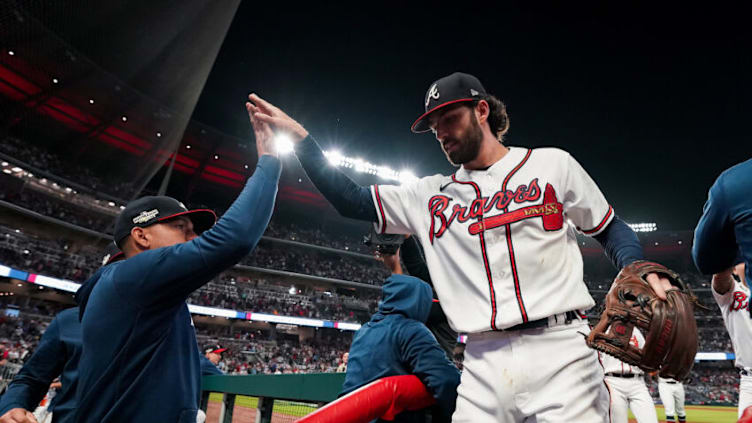 ATLANTA, GA - OCTOBER 12: Dansby Swanson #7 of the Atlanta Braves is congratulated teammates after making a diving catch against the Philadelphia Phillies during the sixth inning in game two of the National League Division Series at Truist Park on October 12, 2022 in Atlanta, Georgia. (Photo by Kevin D. Liles/Atlanta Braves/Getty Images)