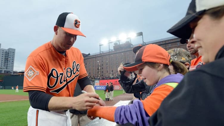 BALTIMORE, MD - APRIL 22: Mark Trumbo #45 of the Baltimore Orioles signs autographs before the game against the Boston Red Sox at Oriole Park at Camden Yards on April 22, 2017 in Baltimore, Maryland. (Photo by Greg Fiume/Getty Images)