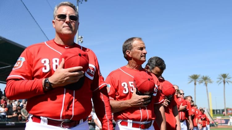 Mar 4, 2016; Goodyear, AZ, USA; Cincinnati Reds manager Bryan Price (38) and Reds bench coach Jim Riggleman (35) look on during the national anthem prior to facing the San Francisco Giants at Goodyear Ballpark. Mandatory Credit: Joe Camporeale-USA TODAY Sports