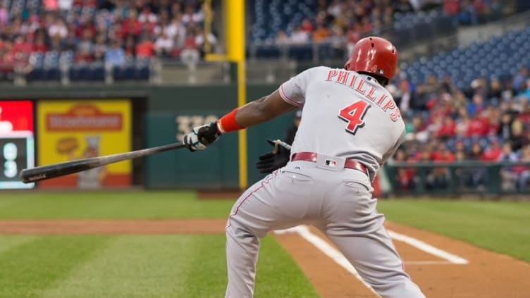 May 14, 2016; Philadelphia, PA, USA; Cincinnati Reds second baseman Brandon Phillips (4) hits an RBI Sacrifice fly during the first inning against the Philadelphia Phillies at Citizens Bank Park. Mandatory Credit: Bill Streicher-USA TODAY Sports