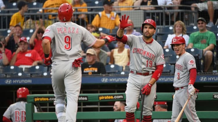 PITTSBURGH, PA - SEPTEMBER 05: Jose Peraza #9 of the Cincinnati Reds is greeted at home plate by Joey Votto #19 and Scooter Gennett #3 after hitting a solo home run in the first inning during the game against the Pittsburgh Pirates at PNC Park on September 5, 2018 in Pittsburgh, Pennsylvania. (Photo by Justin Berl/Getty Images)