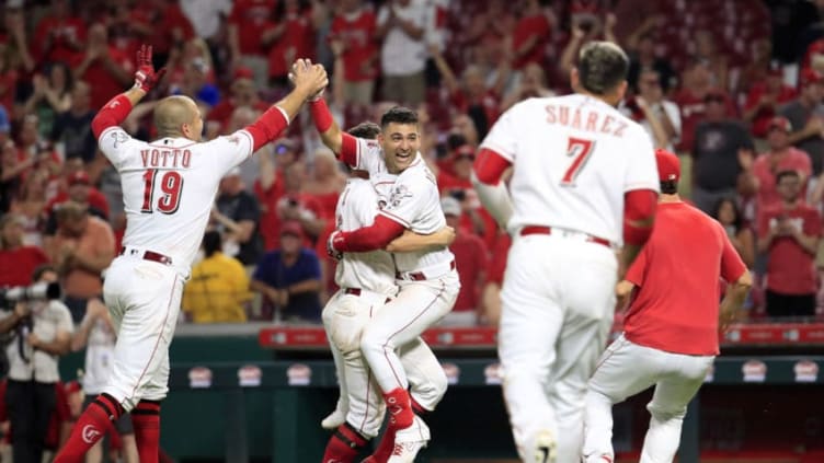 CINCINNATI, OHIO - JULY 02: Joey Votto #19 of the Cincinnati Reds celebrates with Nick Senzel #15 and Jose Iglesias #4 after the 5-4 win in 11 innings against the Milwaukee Brewers at Great American Ball Park on July 02, 2019 in Cincinnati, Ohio. Iglesias hit a game winning single that drove in Yasiel Puig #66 in the 11th inning. (Photo by Andy Lyons/Getty Images)