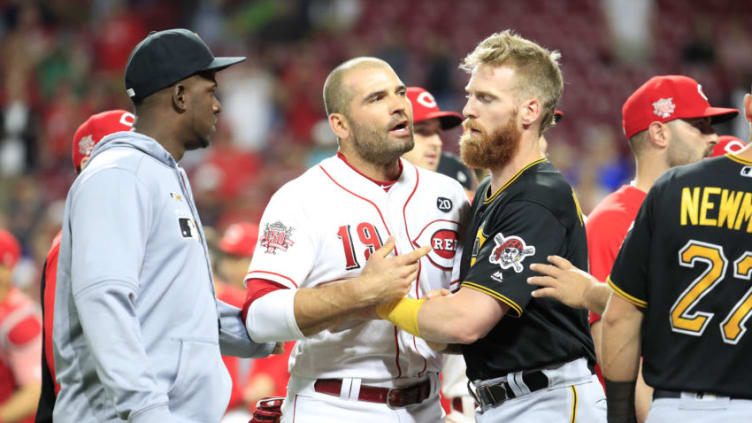 CINCINNATI, OHIO - JULY 30: Joey Votto #19 of the Cincinnati Reds is restrained by Colin Moran #19 of the Pittsburgh Pirates during a bench clearing altercation in the 9th inning of the gameat Great American Ball Park on July 30, 2019 in Cincinnati, Ohio. (Photo by Andy Lyons/Getty Images)