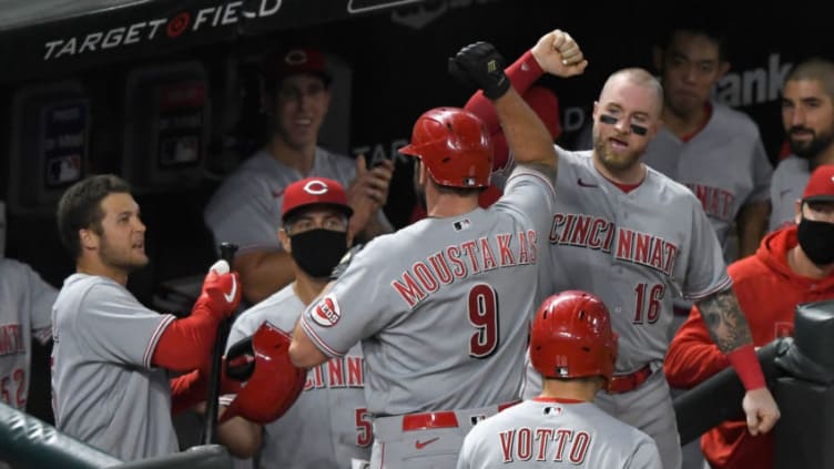 MINNEAPOLIS, MINNESOTA - SEPTEMBER 25: The Cincinnati Reds congratulate teammate Mike Moustakas #9 on a two-run home run. (Photo by Hannah Foslien/Getty Images)