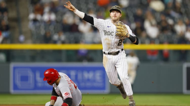 DENVER, CO - MAY 15: Trevor Story #27 of the Colorado Rockies throws to first base to complete the double play as Nick Castellanos #2 of the Cincinnati Reds slides. (Photo by Justin Edmonds/Getty Images)