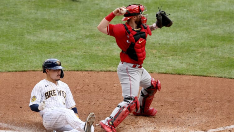 MILWAUKEE, WISCONSIN - AUGUST 09: Tucker Barnhart #16 of the Cincinnati Reds forces out Keston Hiura. (Photo by Dylan Buell/Getty Images)