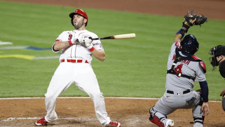 CINCINNATI, OH - SEPTEMBER 02: Mike Moustakas #9 of the Cincinnati Reds falls backward to avoid being hit by a pitch. (Photo by Joe Robbins/Getty Images)