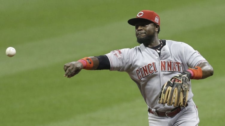 MILWAUKEE, WI - SEPTEMBER 18: Brandon Phillips #4 of the Cincinnati Reds makes the throw to first base to retire Jean Segura of the Milwaukee Brewers in the third inning at Miller Park on September 18, 2015 in Milwaukee, Wisconsin. (Photo by Mike McGinnis/Getty Images)