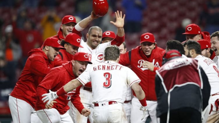 CINCINNATI, OH - APRIL 24: Scooter Gennett #3 of the Cincinnati Reds celebrates with teammates after hitting a game winning two-run home run in the 12th inning against the Atlanta Braves at Great American Ball Park on April 24, 2018 in Cincinnati, Ohio. The Reds won 9-7 in 12 innings. (Photo by Joe Robbins/Getty Images)