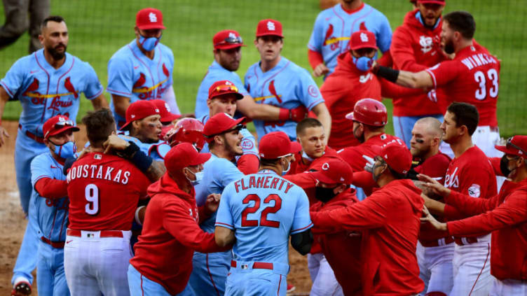 CINCINNATI, OHIO - APRIL 03: Benches clear after Nick Castellanos #2 of the Cincinnati Reds slides safely into home base to score on a wild pitch. (Photo by Emilee Chinn/Getty Images)