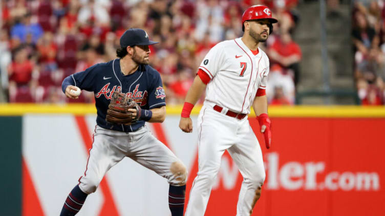 CINCINNATI, OHIO - JUNE 24: Dansby Swanson #7 of the Atlanta Braves attempts to turn a double play past Eugenio Suarez #7 of the Cincinnati Reds in the sixth inning at Great American Ball Park on June 24, 2021 in Cincinnati, Ohio. (Photo by Dylan Buell/Getty Images)