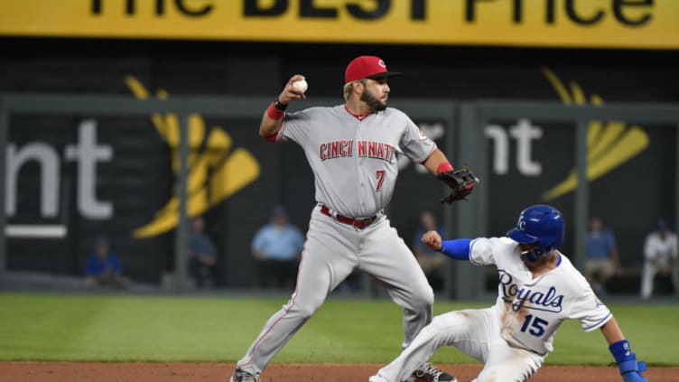 KANSAS CITY, MO - JUNE 12: Eugenio Suarez #7 of the Cincinnati Reds throws to first past Whit Merrifield #15 of the Kansas City Royals (Photo by Ed Zurga/Getty Images)