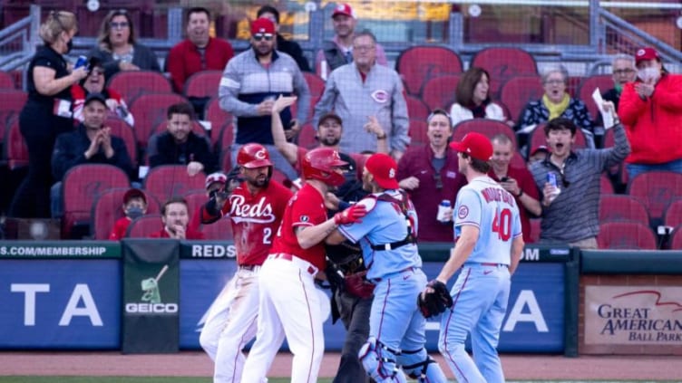 St. Louis Cardinals starting pitcher Jake Woodford (40) and St. Louis Cardinals catcher Yadier Molina (4) charge Cincinnati Reds right fielder Nick Castellanos (2) as Cincinnati Reds second baseman Jonathan India (6) holds them back in the fourth inning.