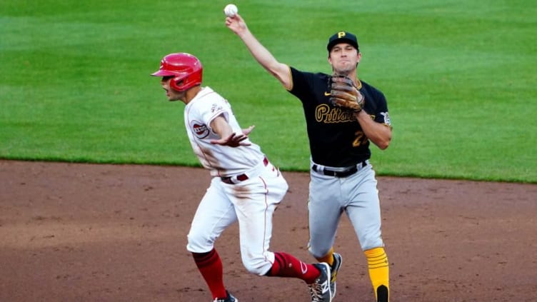 Cincinnati Reds center fielder Nick Senzel (15) signals he's safe.