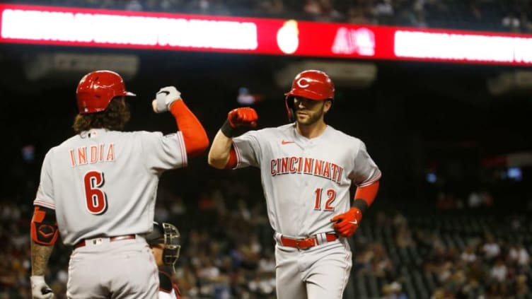 April 9, 2021; Phoenix, Arizona, USA; Reds' Tyler Naquin (12) celebrates with Jonathan India (6) after hitting a home run. Mandatory Credit: Patrick Breen-Arizona Republic