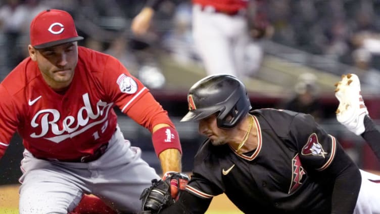 Apr 10, 2021; Phoenix, Arizona, USA; Arizona Diamondbacks left fielder Tim Locastro (16) is tagged out by Cincinnati Reds first baseman Joey Votto. Mandatory Credit: Rick Scuteri-USA TODAY Sports