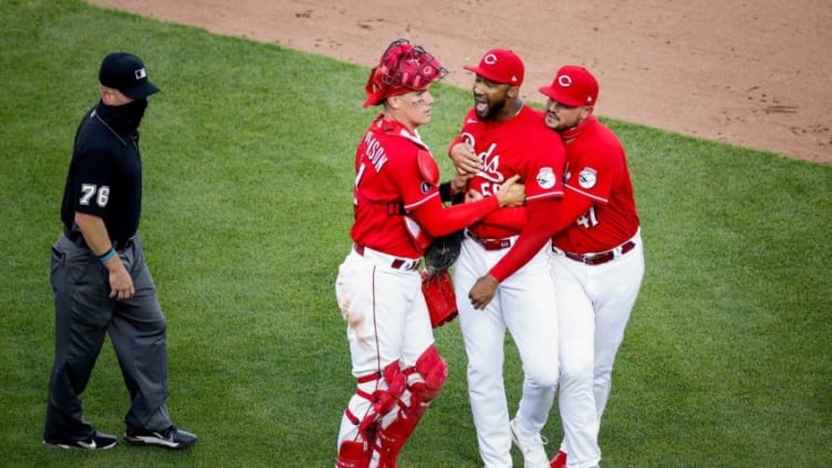 Cincinnati Reds catcher Tyler Stephenson (37) and Cincinnati Reds starting pitcher Sal Romano (47) hold back Cincinnati Reds relief pitcher Amir Garrett (50) as the benches clear in the eighth inning.