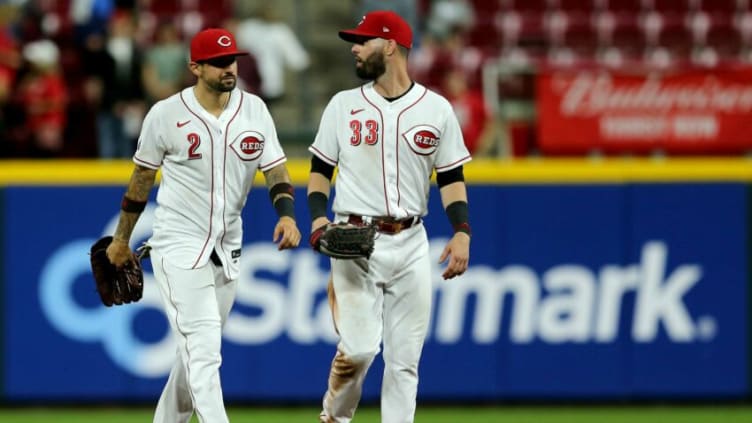 Cincinnati Reds right fielder Nick Castellanos (2), left, and Cincinnati Reds right fielder Jesse Winker (33), walk in from the outfield.