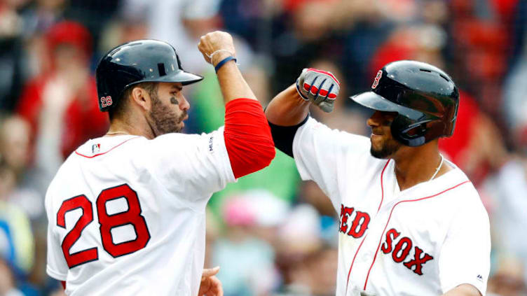 BOSTON, MASSACHUSETTS - APRIL 14: Xander Bogaerts #2 of the Boston Red Sox and J.D. Martinez #28 of the Boston Red Sox celebrate after crossing home plate in the bottom of the eighth inning of the game against the Baltimore Orioles at Fenway Park on April 14, 2019 in Boston, Massachusetts. (Photo by Omar Rawlings/Getty Images)