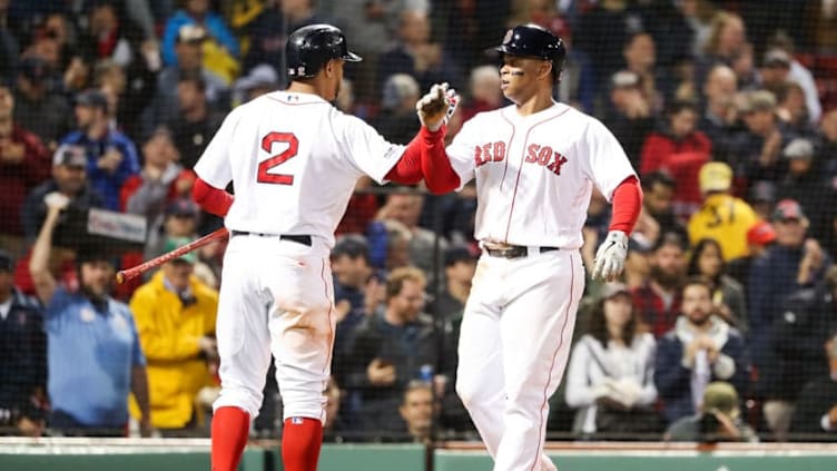 BOSTON, MA - JUNE 13: Rafael Devers #11 high fives Xander Bogaerts #2 of the Boston Red Sox after hitting a solo home run in the fifth inning of a game against the Texas Rangers at Fenway Park on June 13, 2019 in Boston, Massachusetts. (Photo by Adam Glanzman/Getty Images)