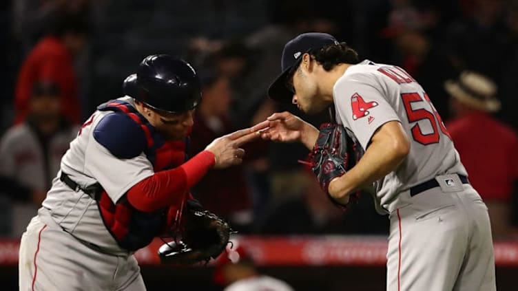 ANAHEIM, CA - APRIL 19: Catcher Christian Vazquez #7 and closing pitcher Joe Kelly #56 of the Boston Red Sox celebrate their 8-2 win after the last out in the ninth inning of the MLB game against the Los Angeles Angels of Anaheim at Angel Stadium on April 19, 2018 in Anaheim, California. (Photo by Victor Decolongon/Getty Images)