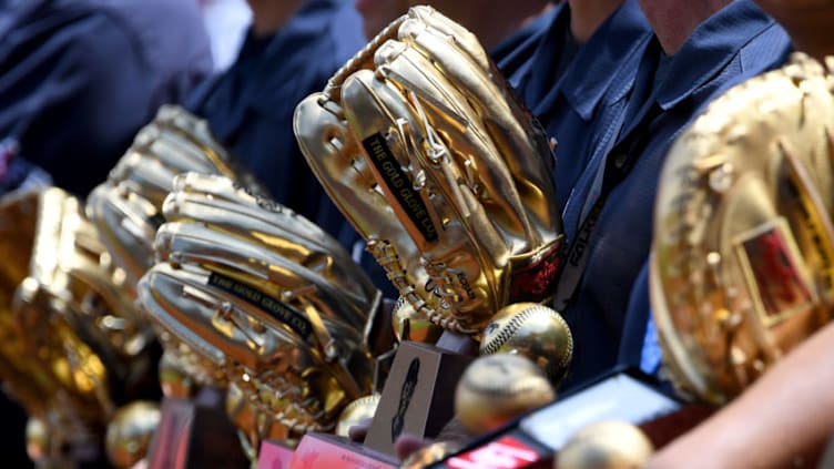 ANAHEIM, CA - APRIL 06: Los Angeles Angels of Anaheim stadium workers hold a display of players gold glove awards on the field before the game Texas Rangers of Anaheim on April 6, 2019 in Anaheim, California. (Photo by Jayne Kamin-Oncea/Getty Images)