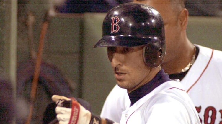 Nomar Garciaparra of the Boston Red Sox is congratulated by teammates after hitting a homer in the sixth inning against the New York Yankees 24 May 2002 at Fenway Park in Boston Massachusetts. AFP PHOTO/JOHN MOTTERN (Photo by JOHN MOTTERN / AFP) (Photo by JOHN MOTTERN/AFP via Getty Images)