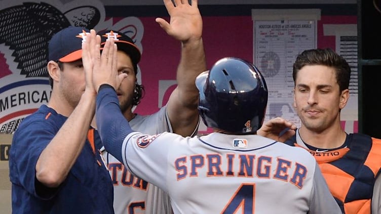 May 28, 2016; Anaheim, CA, USA; Houston Astros right fielder George Springer (4) is greeted in the dugout after scoring a run in the first inning of the game against the Los Angeles Angels at Angel Stadium of Anaheim. Mandatory Credit: Jayne Kamin-Oncea-USA TODAY Sports