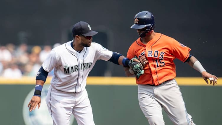 SEATTLE, WA - AUGUST 22: Third baseman Robinson Cano #22 of the Seattle Mariners tags out Martin Maldonado #15 of the Houston Astros on a ball hit by Jose Altuve #27 of the Houston Astros during the second inning of a game at Safeco Field on August 22, 2018 in Seattle, Washington. (Photo by Stephen Brashear/Getty Images)