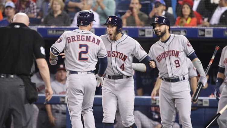 TORONTO, ON - SEPTEMBER 25: Alex Bregman #2 of the Houston Astros is congratulated by George Springer #4 after hitting a two-run home run in the first inning during MLB game action against the Toronto Blue Jays at Rogers Centre on September 25, 2018 in Toronto, Canada. (Photo by Tom Szczerbowski/Getty Images)