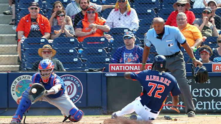 WEST PALM BEACH, FL - MARCH 11: Yordan Alvarez #72 of the Houston Astros scores before catcher Tomas Nido #3 of the New York Mets can make a tag on a ball off the bat of Nick Tanielu during the ninth inning of a spring training baseball game against the Houston Astros at Fitteam Ballpark of the Palm Beaches on March 11, 2019 in West Palm Beach, Florida. The Astros defeated the Mets 6-3. (Photo by Rich Schultz/Getty Images)