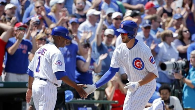 Jun 2, 2016; Chicago, IL, USA; Chicago Cubs third baseman Kris Bryant (17) high fives third base coach Gary Jones (1) after hitting a home run against the Los Angeles Dodgers in the fifth inning at Wrigley Field. Mandatory Credit: Kamil Krzaczynski-USA TODAY Sports