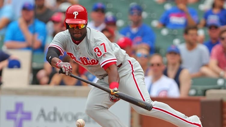 May 28, 2016; Chicago, IL, USA; Philadelphia Phillies center fielder Odubel Herrera (37) hits a bunt single during the first inning against the Chicago Cubs at Wrigley Field. Mandatory Credit: Dennis Wierzbicki-USA TODAY Sports