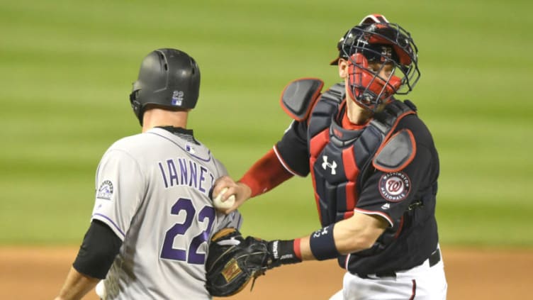 WASHINGTON, DC - APRIL 12: Matt Wieters #32 of the Washington Nationals tags out Chris Iannetta #22 of the Colorado Rockies who tried to score on Ian Desmond #20 (not pictured) ground ball in the fifth inning during a baseball game at Nationals Park on April 12, 2018 in Washington, DC. (Photo by Mitchell Layton/Getty Images)