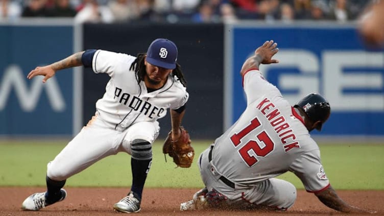 SAN DIEGO, CA - MAY 9: Howie Kendrick #12 of the Washington Nationals is tagged out by Freddy Galvis #13 of the San Diego Padres as he tries to steal second base during the fourth inning of a baseball game at PETCO Park on May 9, 2018 in San Diego, California. (Photo by Denis Poroy/Getty Images)