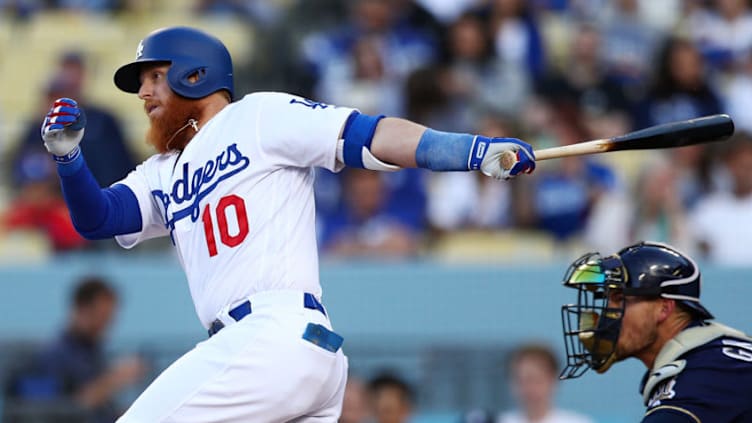 LOS ANGELES, CALIFORNIA - APRIL 13: Justin Turner #10 of the Los Angeles Dodgers hits a single against the Milwaukee Brewers during the first inning at Dodger Stadium on April 13, 2019 in Los Angeles, California. (Photo by Yong Teck Lim/Getty Images)