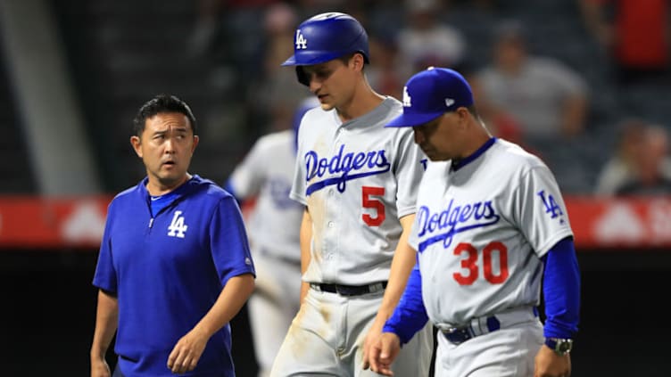 ANAHEIM, CALIFORNIA - JUNE 11: Manager Dave Roberts and team trainer walk Corey Seager #5 of the Los Angeles Dodgers off the field after he was injured rounding third base during the ninth inning of a game against the Los Angeles Dodgers at Angel Stadium of Anaheim on June 11, 2019 in Anaheim, California. (Photo by Sean M. Haffey/Getty Images)