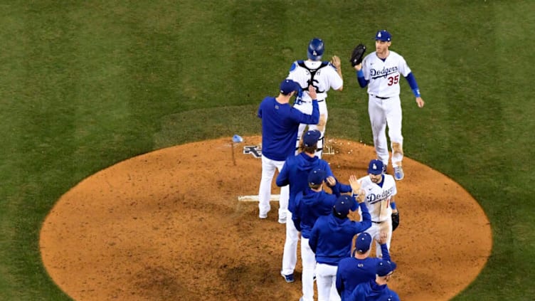 LOS ANGELES, CALIFORNIA - OCTOBER 21: Cody Bellinger #35 and AJ Pollock #11 of the Los Angeles Dodgers celebrate a 11-2 win over the Atlanta Braves during game five of the National League Championship Series at Dodger Stadium on October 21, 2021 in Los Angeles, California. (Photo by Harry How/Getty Images)