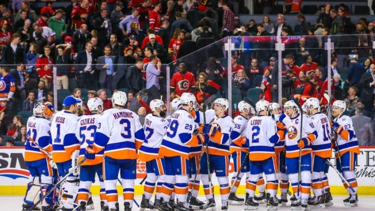 Feb 25, 2016; Calgary, Alberta, CAN; New York Islanders players celebrate win over Calgary Flames during the overtime period at Scotiabank Saddledome. New York Islanders won 2-1. Mandatory Credit: Sergei Belski-USA TODAY Sports