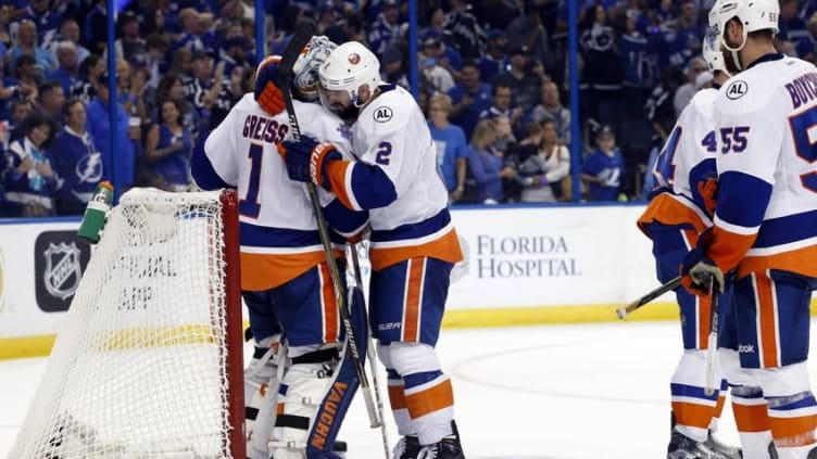 May 8, 2016; Tampa, FL, USA; New York Islanders goalie Thomas Greiss (1) and defenseman Nick Leddy (2) hug after they lost to the Tampa Bay Lightning in game five of the second round of the 2016 Stanley Cup Playoffs at Amalie Arena. Tampa Bay Lightning defeated the New York Islanders 4-0. Mandatory Credit: Kim Klement-USA TODAY Sports