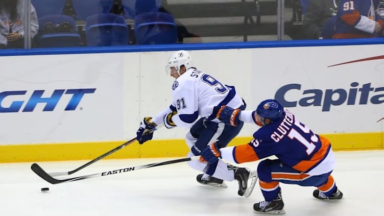 Nov 18, 2014; Uniondale, NY, USA; New York Islanders right wing Cal Clutterbuck (15) challenges Tampa Bay Lightning center Steven Stamkos (91) during the first period at Nassau Veterans Memorial Coliseum. Mandatory Credit: Anthony Gruppuso-USA TODAY Sports