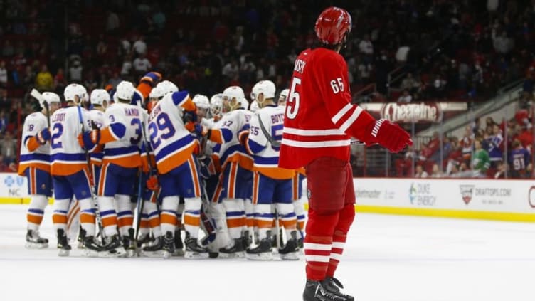 Mar 26, 2016; Raleigh, NC, USA; Carolina Hurricanes defensemen Ron Hainsey (65) watches as the New York Islanders celebrate the overtime win at PNC Arena. The New York Islanders defeated the Carolina Hurricanes 4-3 in the overtime. Mandatory Credit: James Guillory-USA TODAY Sports