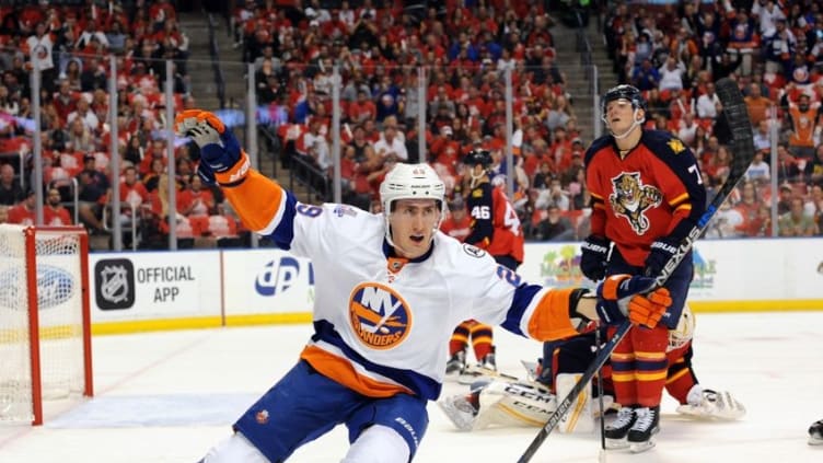 Apr 14, 2016; Sunrise, FL, USA; New York Islanders left winger Brock Nelson (29) celebrates his first period goal as Florida Panthers defenseman Dmitry Kulikov (7) reacts in game one of the first round of the 2016 Stanley Cup Playoffs at BB&T Center. Mandatory Credit: Robert Duyos-USA TODAY Sports