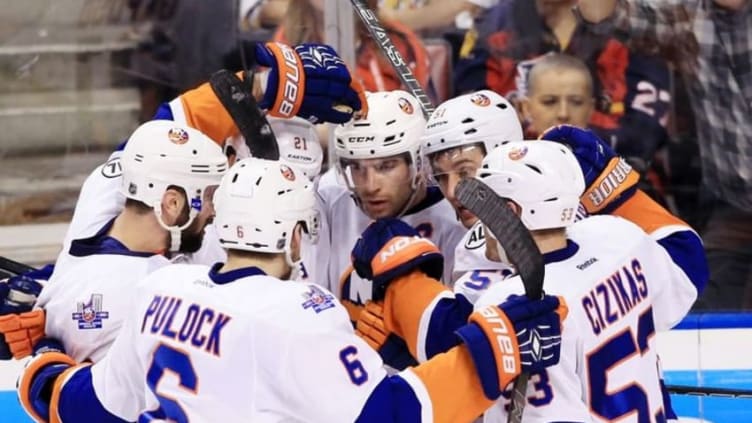 Apr 15, 2016; Sunrise, FL, USA; New York Islanders center John Tavares (91) celebrates his goal with right wing Kyle Okposo (21) center Frans Nielsen (51) defenseman Ryan Pulock (6) and center Casey Cizikas (53) in the third period in game two of the first round of the 2016 Stanley Cup Playoffs against the Florida Panthers at BB&T Center. The Panthers won 3-1. Mandatory Credit: Robert Mayer-USA TODAY Sports