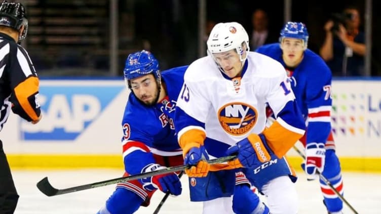 Sep 27, 2016; New York, NY, USA; New York Rangers center Mika Zibanejad (93) and New York Islanders center Mathew Barzal (13) battle for a loose puck during the first period during a preseason hockey game at Madison Square Garden. Mandatory Credit: Andy Marlin-USA TODAY Sports