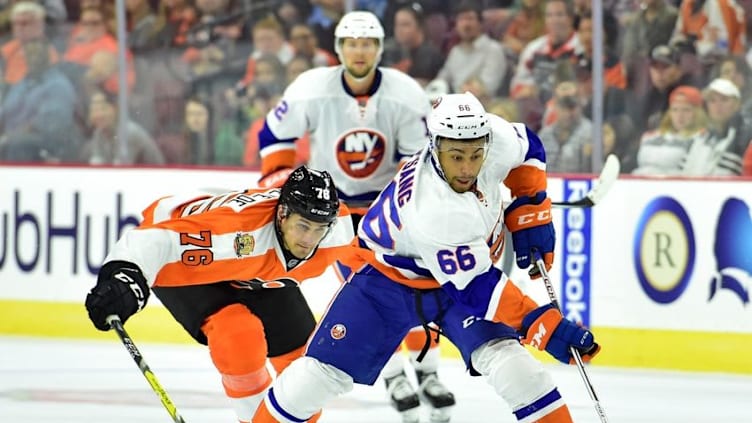 Sep 27, 2016; Philadelphia, PA, USA; New York Islanders right wing Josh Ho-Sang (66) carries the puck past Philadelphia Flyers center Chris VandeVelde (76) during the second period during a preseason hockey game at Wells Fargo Center. Mandatory Credit: Eric Hartline-USA TODAY Sports