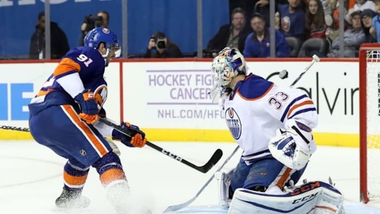 Nov 5, 2016; Brooklyn, NY, USA; Edmonton Oilers goalie Cam Talbot (33) deflects a puck shot by New York Islanders center John Tavares (91) during overtime at Barclays Center. Edmonton Oilers won in shootout 4-3. Mandatory Credit: Anthony Gruppuso-USA TODAY Sports